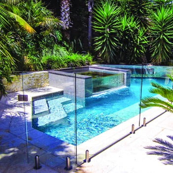 Glass pool fence around a swimming pool
